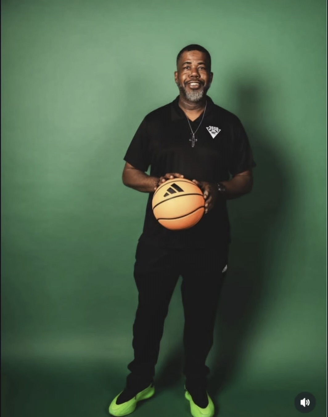 Coach Harris holding a basketball in Atlanta Celtics inspired colors
